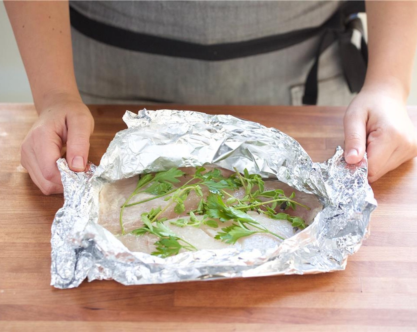 step 6 Pat dry Red Snapper Fillets (2) with paper towels. Place the fillets in the center of two pieces of foil. Add Olive Oil (1 Tbsp) and half of the lemon juice over each fillet. Cover each fillet with two sprigs each of Fresh Oregano (2 sprigs) and Fresh Parsley (2 sprigs).