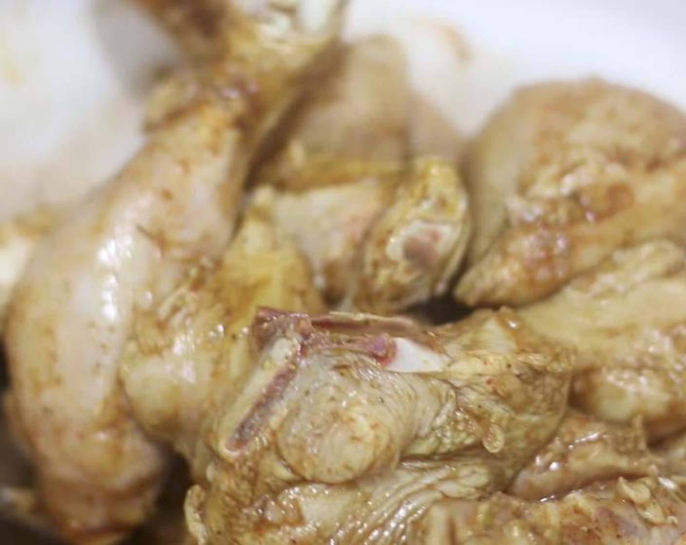 step 1 Place skinned and cut Whole Chicken (1) into a bowl. Add Adobo Seasoning (1/2 Tbsp), Paprika (1 tsp), Dried Oregano (1 tsp), Ground Black Pepper (1/8 tsp), Low-Sodium Soy Sauce (1 Tbsp), Garlic (4 cloves), Limes (2), and Orange (1).