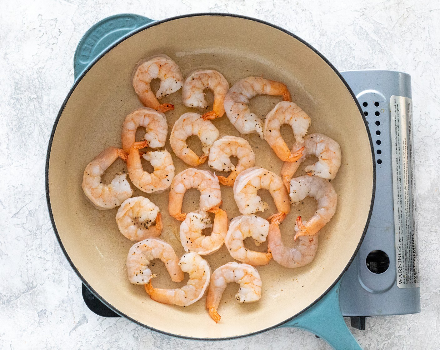 step 4 Heat a large high sided skillet or dutch oven over medium heat. Add Extra-Virgin Olive Oil (1 Tbsp). Once hot, add the shrimp in a single layer. Cook shrimp until it is opaque and pink in color, about 1 to 2 minutes per side. Transfer shrimp to a clean plate.