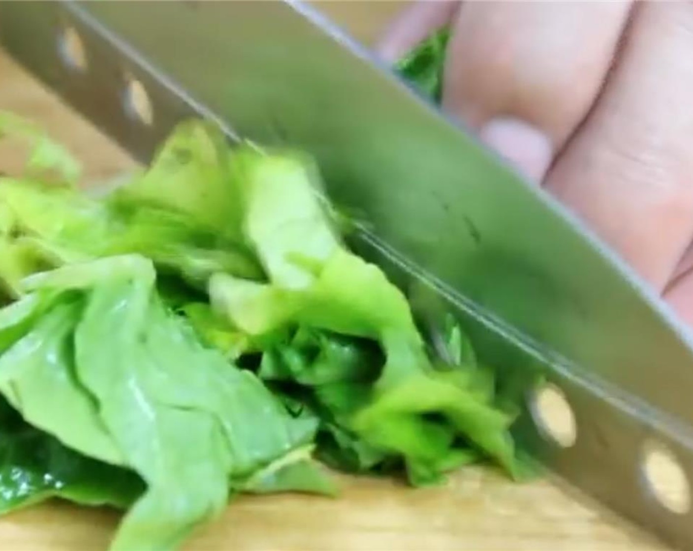 step 3 Separate the leaves from the Romaine Lettuce (1 head). First, slice them vertically and then chop it up. Place in a large bowl.