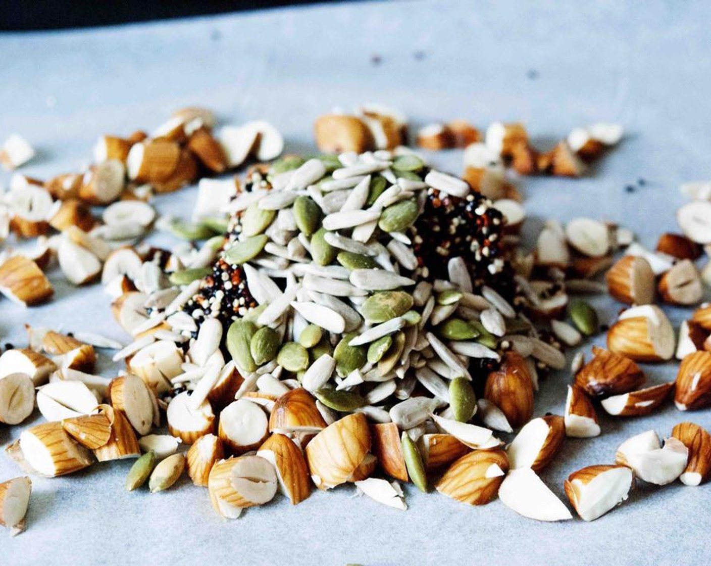 step 5 Place the almonds, Pepitas (4 Tbsp), Raw Sunflower Seeds (4 Tbsp), and quinoa on a baking tray.