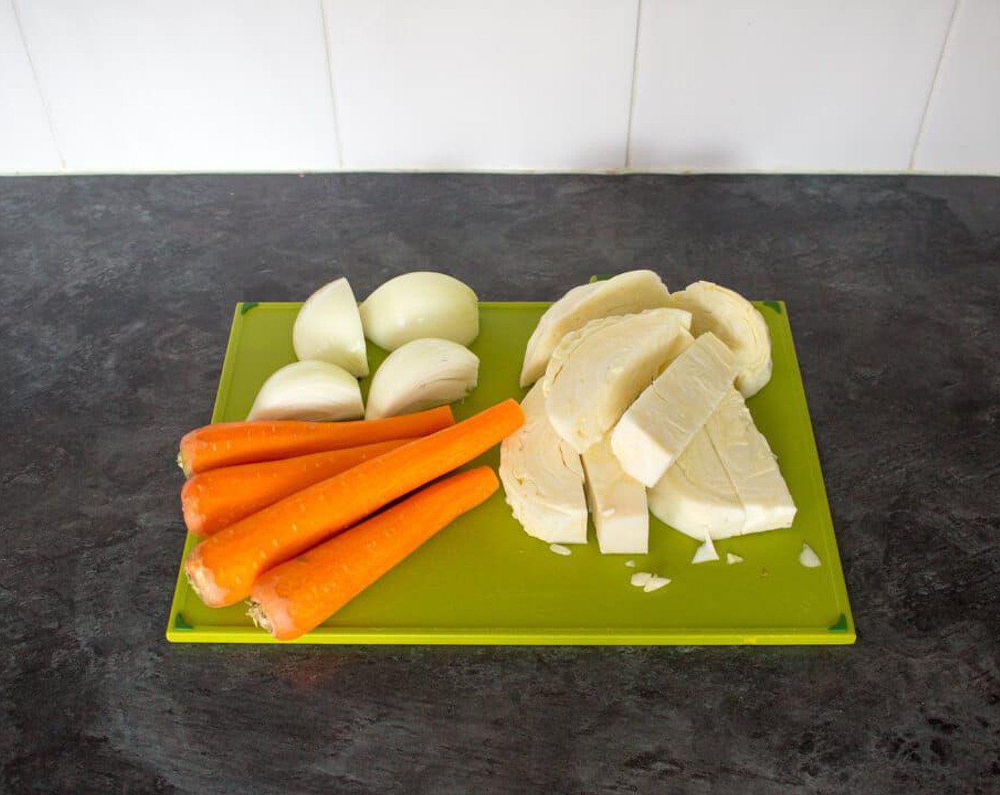 step 1 First thing’s first, prep your vegetables ready for the processor. Chop the Green Cabbage (1/2) up into rough pieces, peel & quarter the Yellow Onion (1), peel the Carrots (4) & chop the tops off.