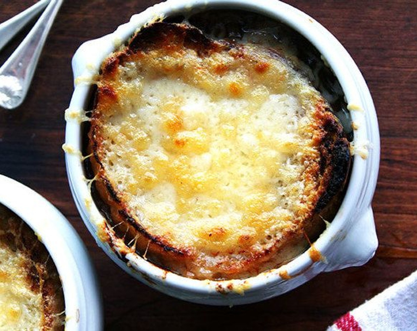 step 12 Portion the soup into bowls, top with a slice of bread, cover with Gruyère Cheese (2 cups). Broil until cheese is melted and nicely browned. Serve immediately.