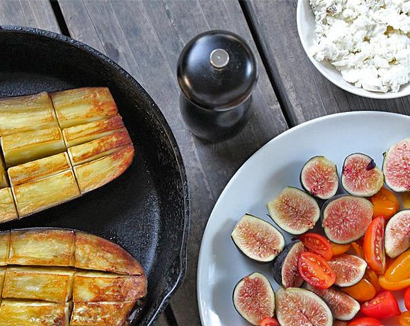 step 6 Take eggplant out of the oven and set oven to broil. Turn eggplant halves over, place the figs and tomatoes on top. Place Aged Goat Cheese (to taste) on top. Sprinkle with Ground Black Pepper (to taste).