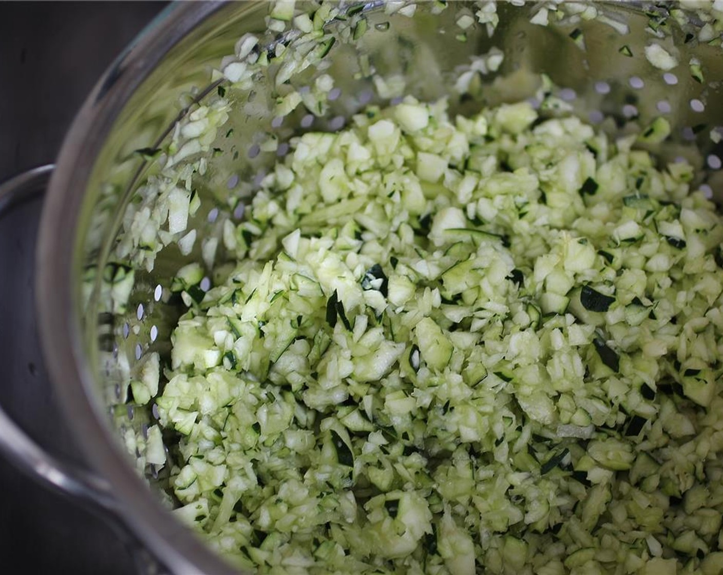 step 1 Start by running the Zucchini (2) through the food processor until the bits are quite small but still retain some texture and aren’t mushed up. Place zucchini into a strainer, sprinkle with salt, and let sit 10-15 minutes.