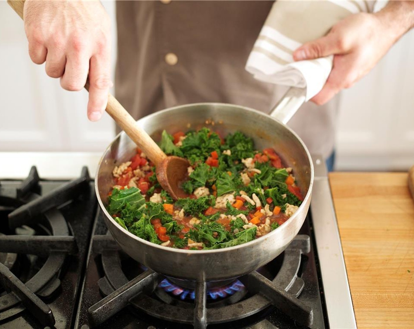 step 8 Add the broth and Canned Tomatoes (2 cups). Bring to a boil over high heat. Stir in the Kale (6 3/4 cups) and reduce heat to medium low. Simmer for ten minutes until vegetables are very tender.