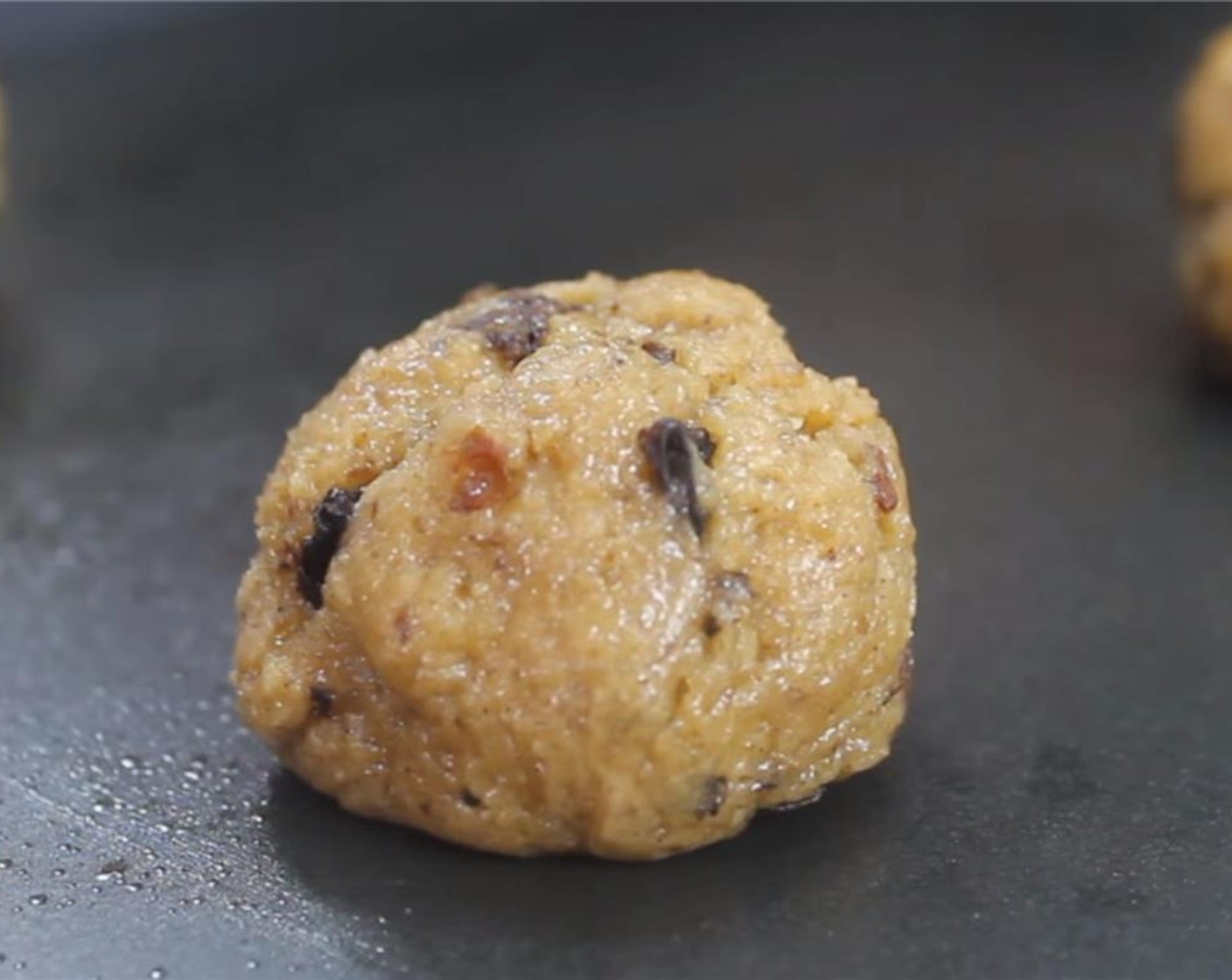 step 7 Line a baking tray with parchment paper or spray with baking spray. Using an ice cream scoop or tablespoon, scoop up a couple of tablespoons of the dough and place it on the cookie tray. You want about 3 inches between the cookies.