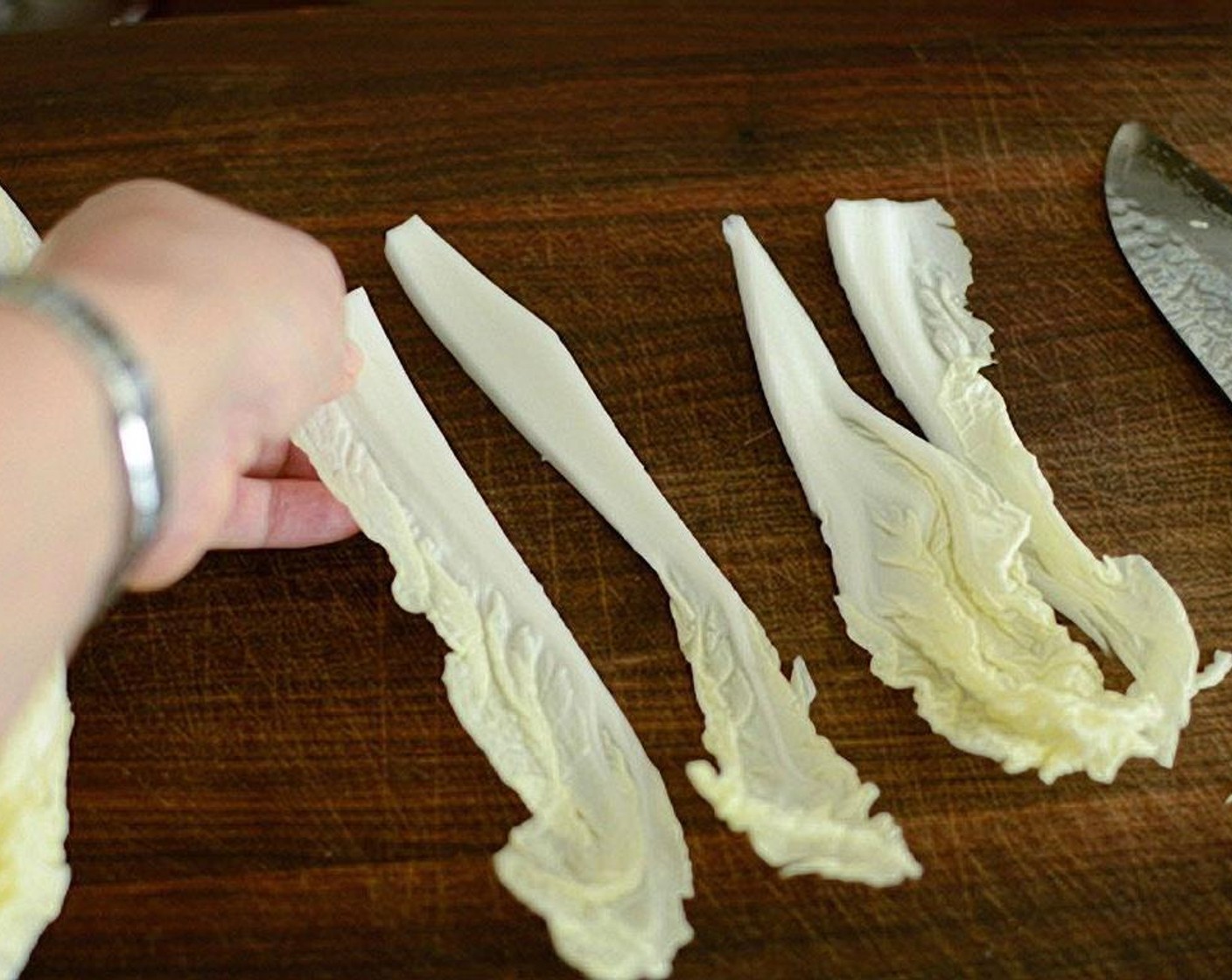 step 3 Take the individual cabbage pieces and place them in a mixing bowl.