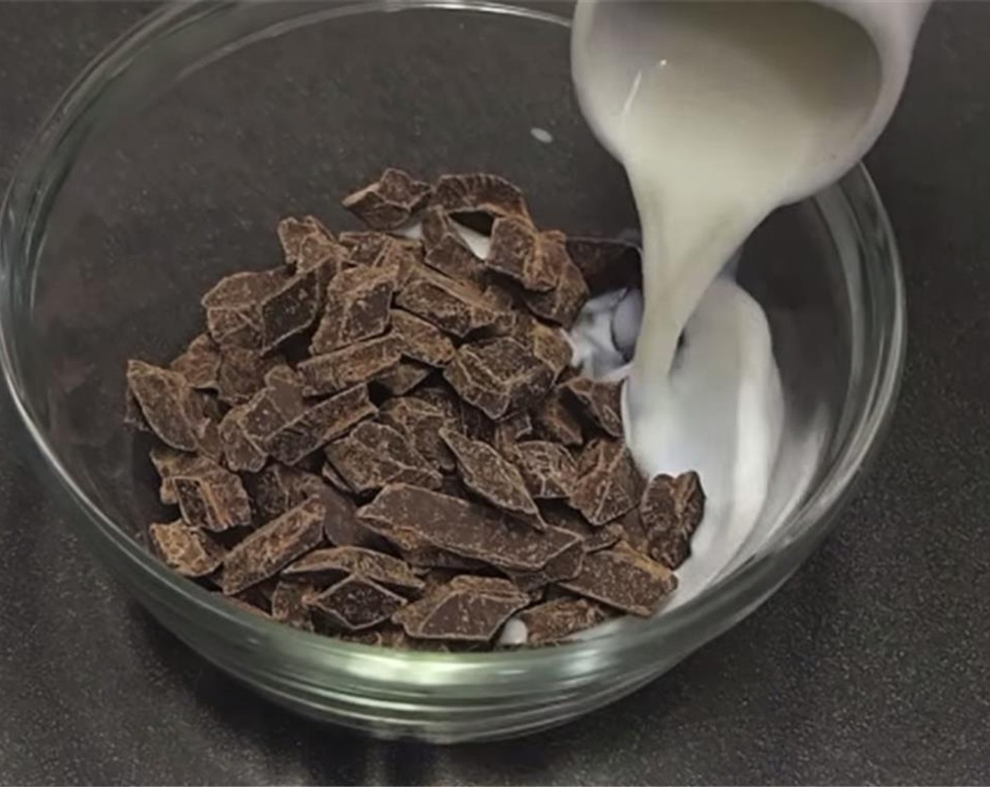 step 6 To make the truffles, pour boiling Heavy Cream (1/2 cup) into the Bittersweet Chocolate (1/2 cup) with the Fine Sea Salt (1/4 tsp) and Rum (1/2 Tbsp). Stir to combine and melt the chocolate. Allow to set in the refrigerator for about an hour.