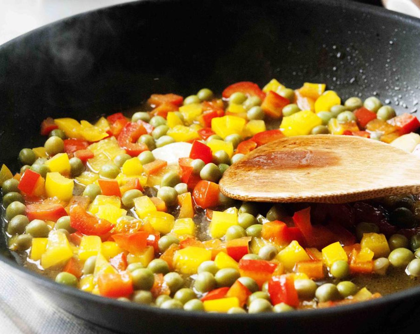 step 4 In a skillet heat Extra-Virgin Olive Oil (2 Tbsp) and sautee the Garlic (2 cloves) until golden in color. Add the diced bell peppers, season with Salt (to taste) and Ground Black Pepper (to taste), and cook on medium-low with a lid on for about 10 min. Add the Green Peas (1/2 cup) and cook for 5 more minutes.