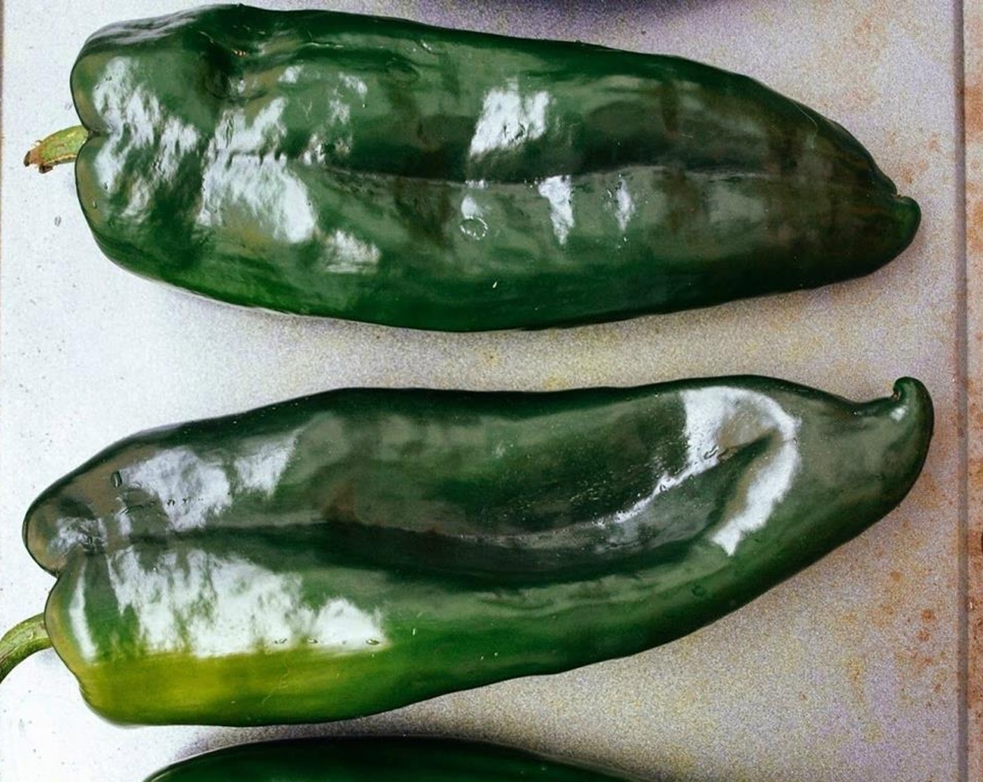 step 5 Roast the Poblano Peppers (4) on a cookie sheet in the oven for 20 minutes or so, turning half way in between to flip peppers over.