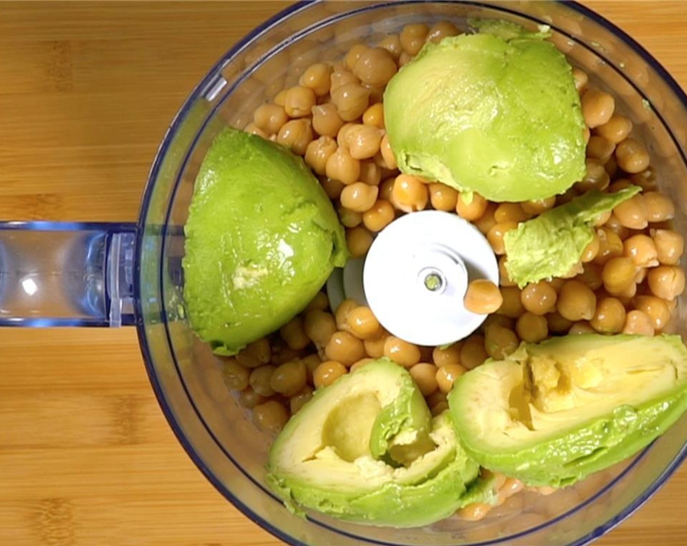 step 7 Pit and halve the Avocados (2) and add to the food processor.