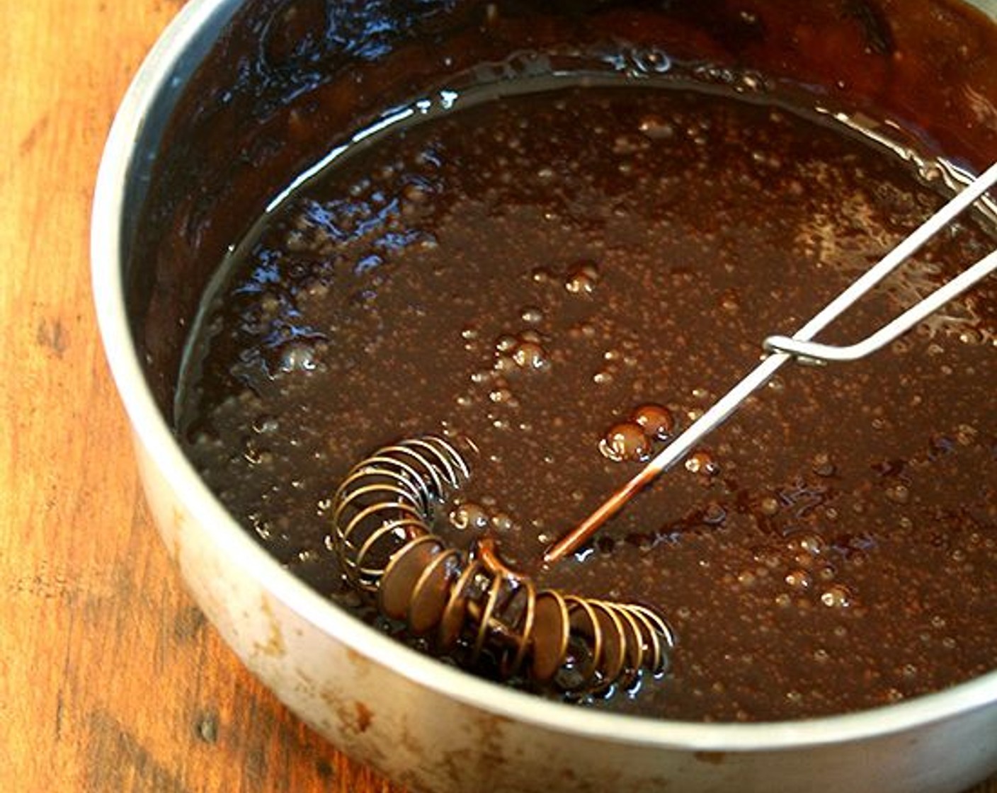 step 8 Meanwhile, make the icing: In a small saucepan over direct heat set on low, melt the Semi-Sweet Chocolate Chips (2/3 cup). Stir in the Powdered Confectioners Sugar (1/4 cup). Stir in the Eggs (3), whisking constantly.