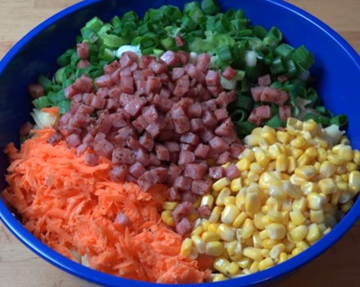 step 3 In a large mixing bowl, toss together the Pasta (14 oz), Carrots (2), Sweet Corn (2 cans), Scallion (1 bunch) and the fried bacon.