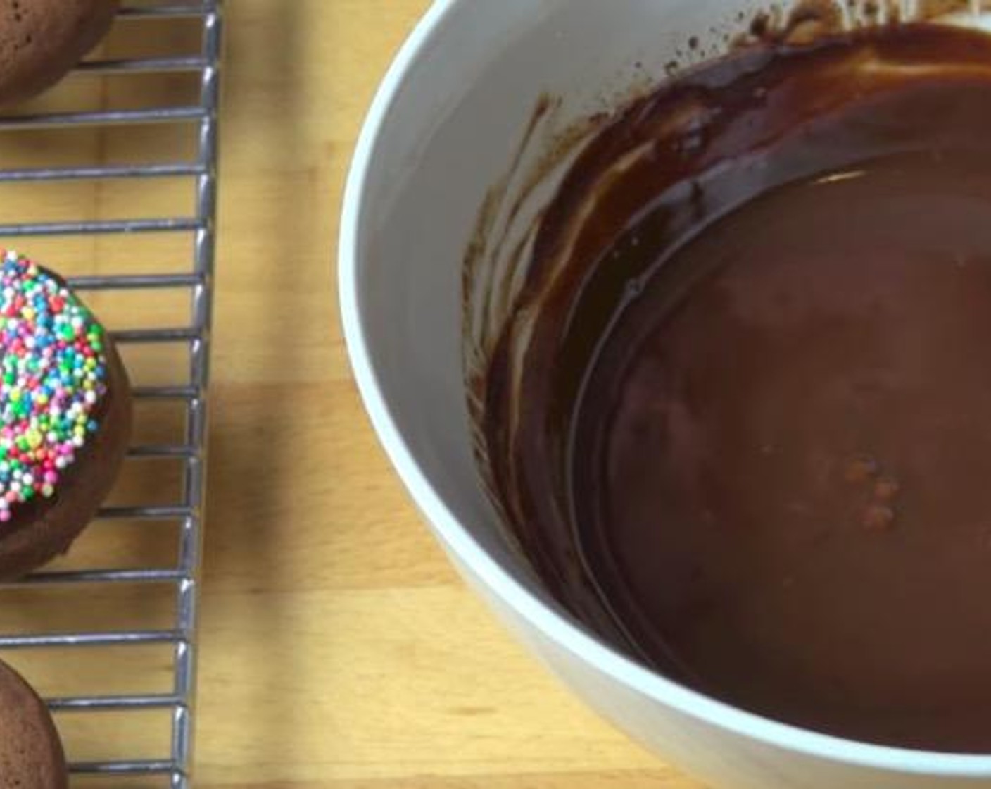 step 4 Take a donut and gently dip it into the ganache. Put some sprinkle on if preferred. Continue on with the rest. Enjoy!