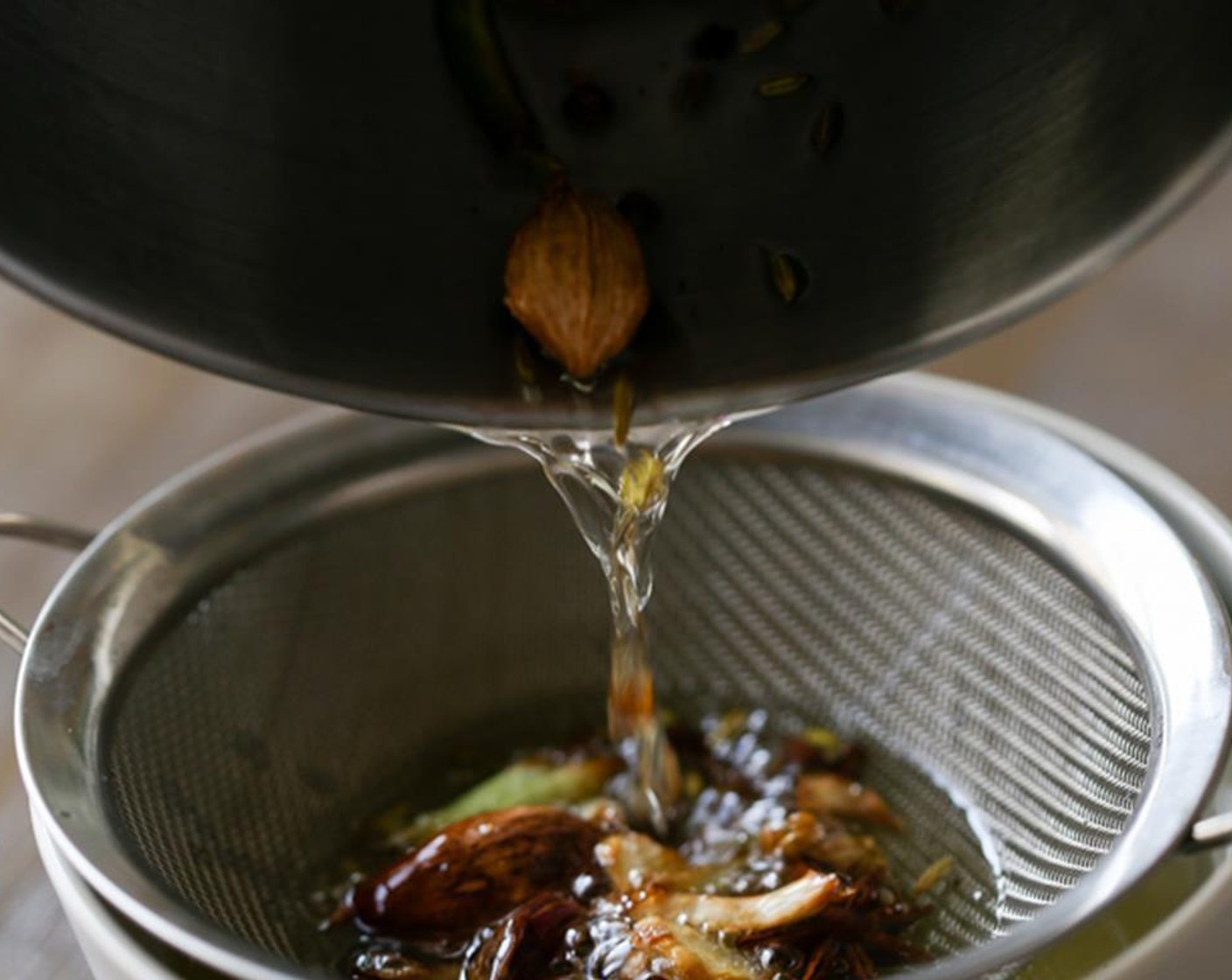 step 2 Cook until the scallion white becomes slightly brown and you can smell the strong aroma. Filter all the spices out and leave the oil in the pot.