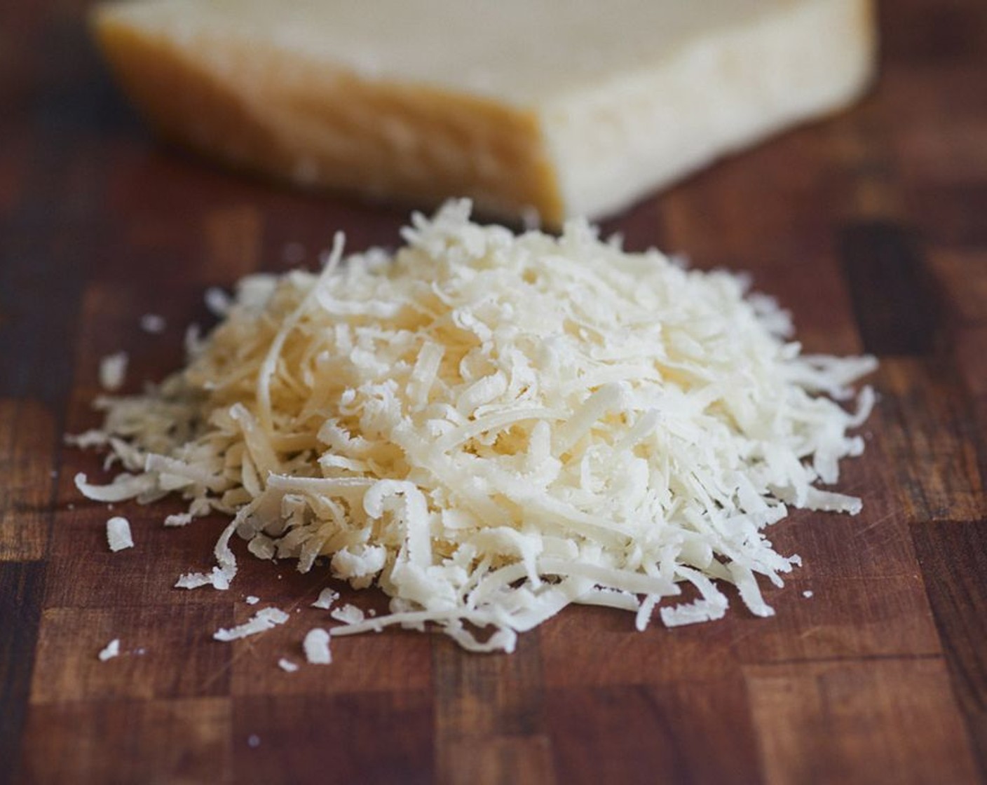 step 2 Grate Parmigiano-Reggiano (2 Tbsp) on the small side of a box grater. I found that it worked better if the cheese was perpendicular to the counter, giving you longer shreds. This gave the frico a lacier texture.