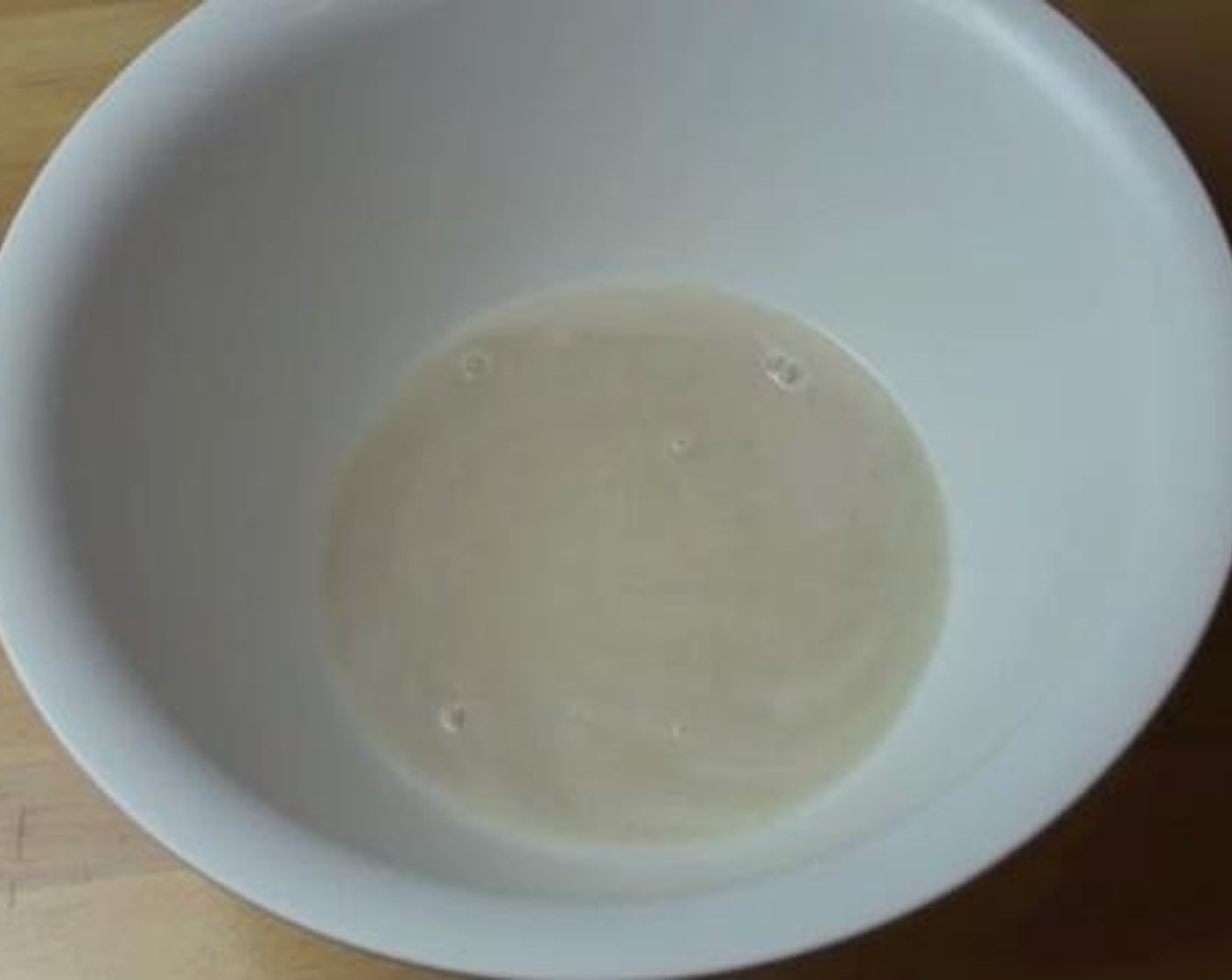 step 3 Into a big bowl, add Water (1 cup), Granulated Sugar (2 Tbsp), and Instant Dry Yeast (2 tsp). Stir everything together for 2 minutes until the yeast foams up.