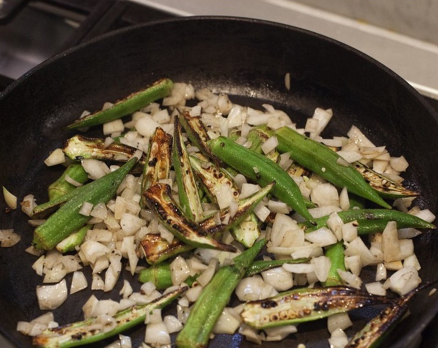 step 10 Transfer steaks to a plate while you cook the Okra. Return the pan to medium-high heat. If the pan is dry, add a little more cooking oil. Add okra, cut side down, and cook 1-2 minutes. Stir in the chopped vidalia onion.