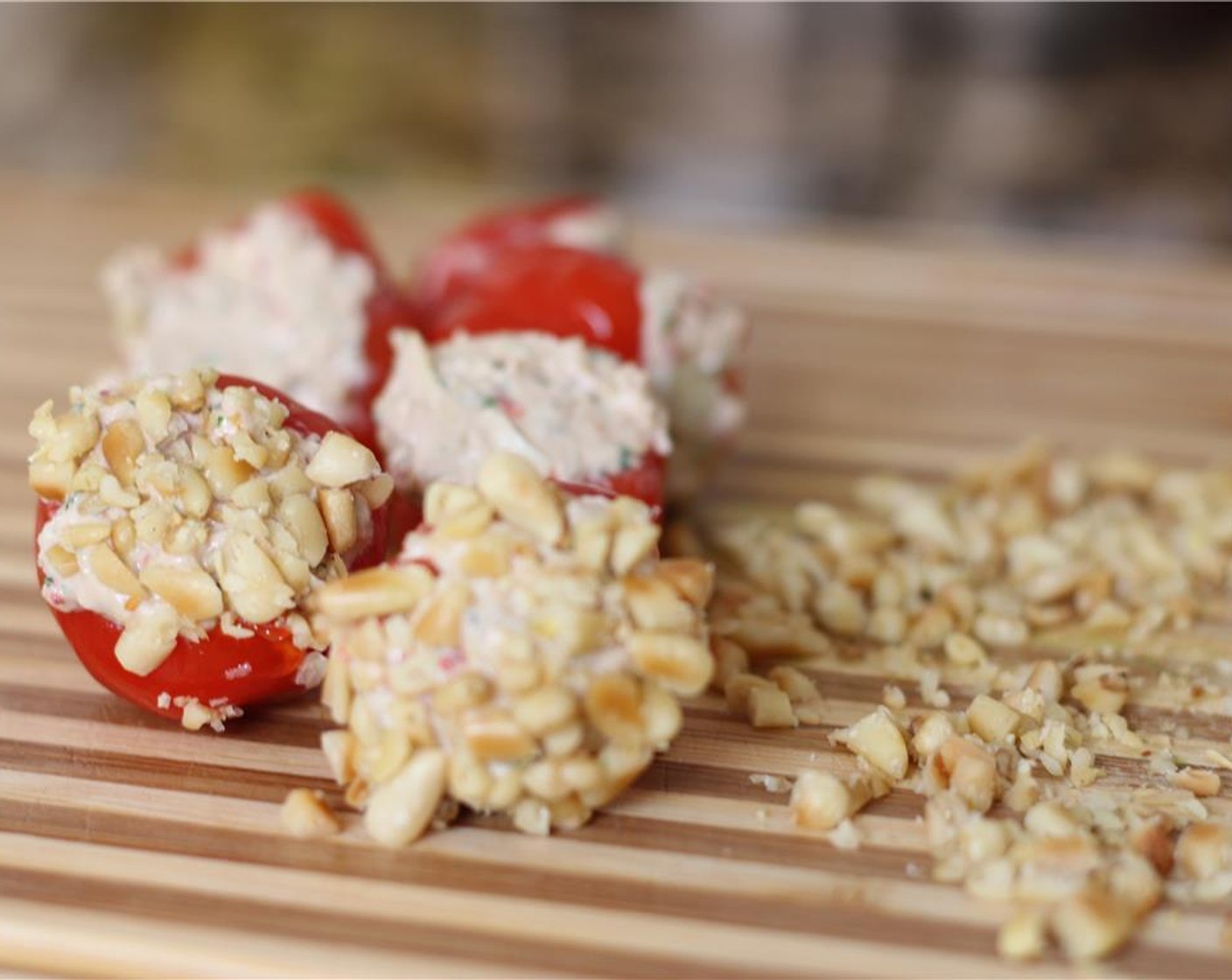 step 8 Roll the cheesy end of each peppadew in the crushed pine nuts. Serve immediately or refrigerate.
