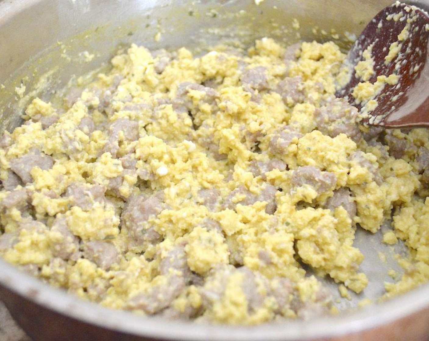 step 4 When the sausage is done, pour in the egg mixture over it and stir it pretty constantly until it is fully cooked into soft, fluffy, sausagey scrambled eggs. Take it off of the heat and stir in the Whipped Chive Cream Cheese (1 Tbsp) for added flavor and creamy texture.