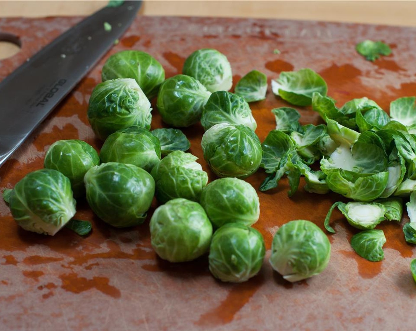 step 2 Cut the woody ends off off the Brussels Sprouts (12). Rinse the brussel sprouts in a bowl of water and dry them. Cut into fine slices.