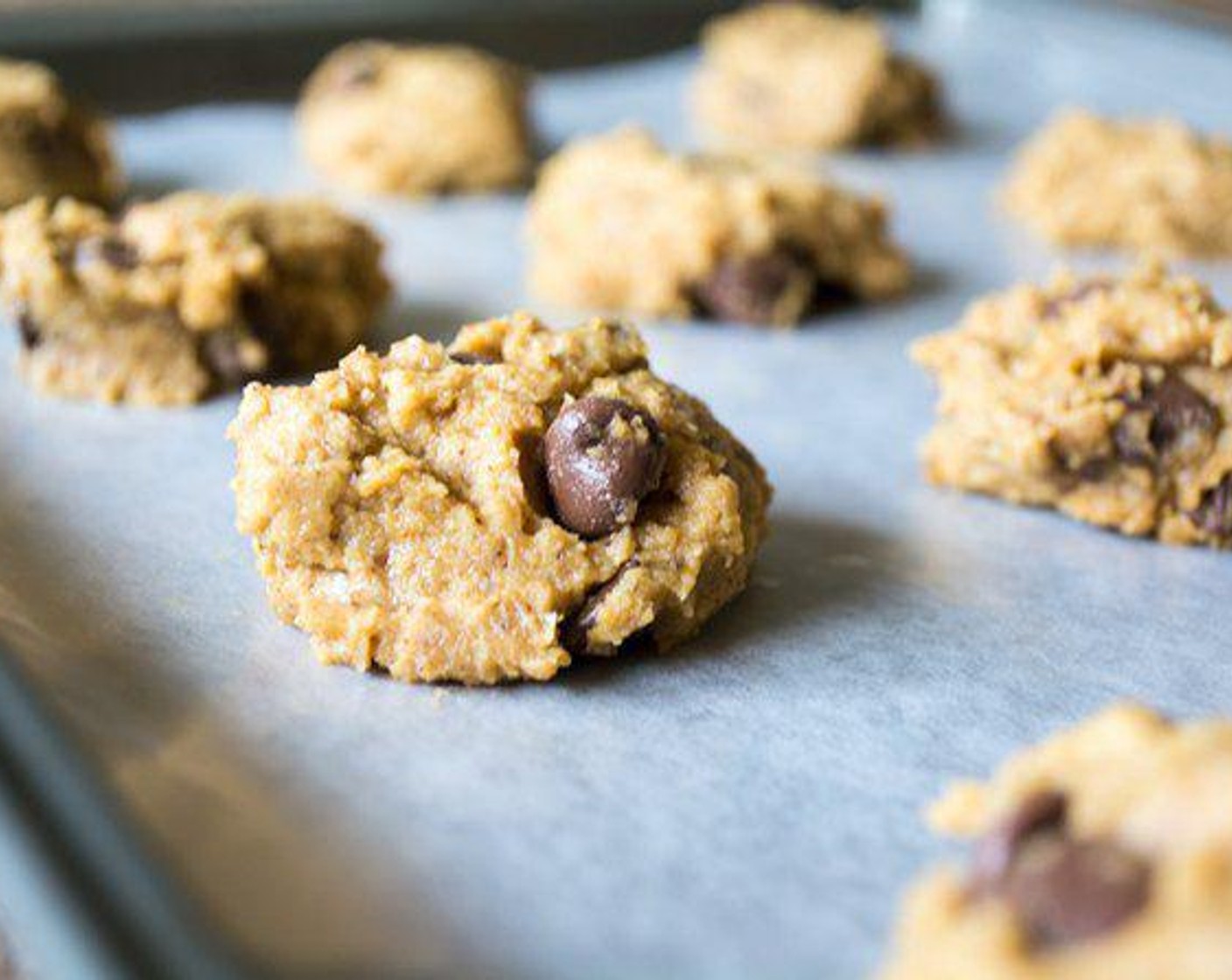 step 4 Preheat the oven to 375 degrees F (190 degrees C) and line baking sheet with parchment paper. Once dough is set, use small spoon and scoop heaping spoonfuls on to the baking sheets.