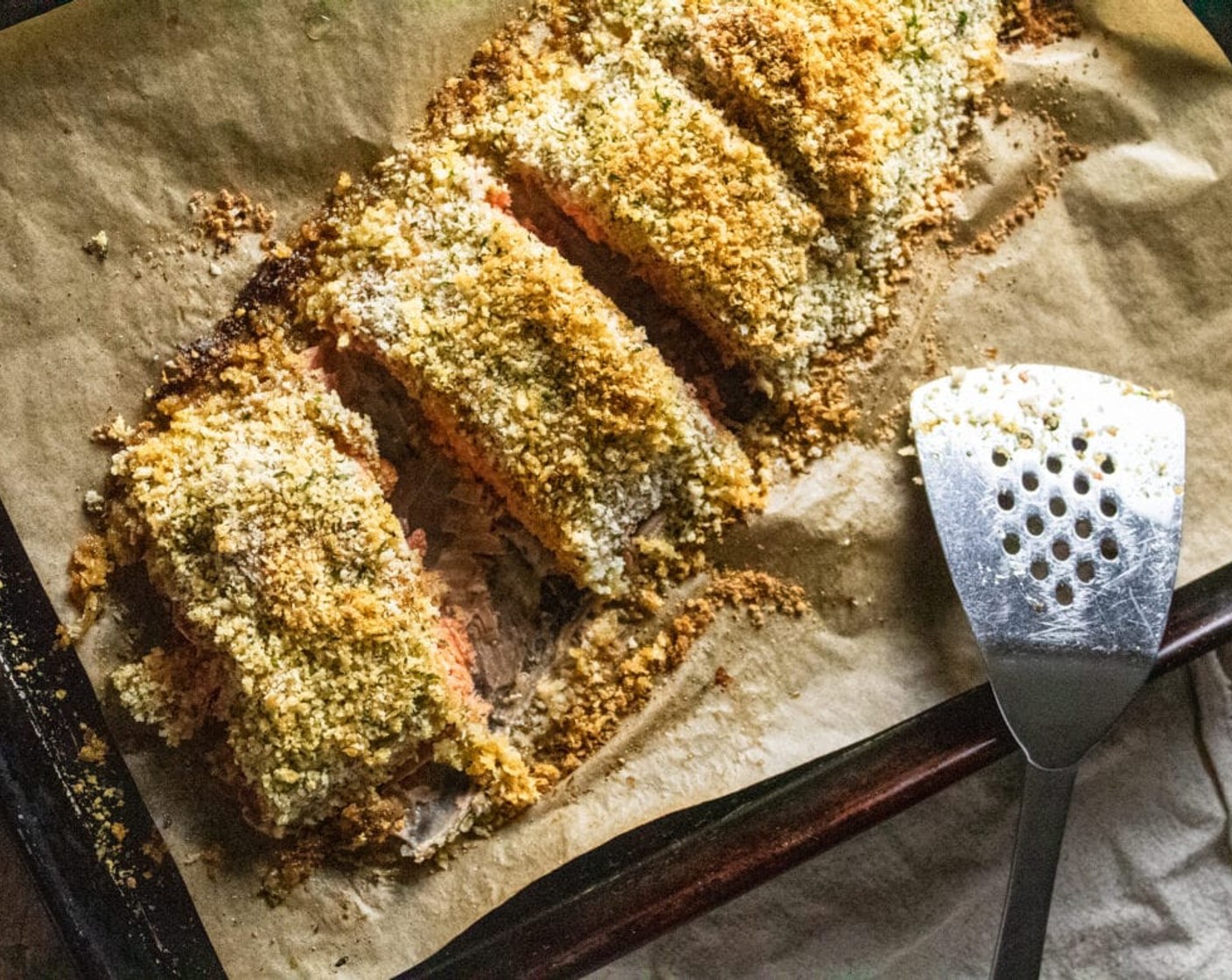 step 6 Drizzle the top of the breadcrumb mixture with Olive Oil (2 Tbsp) and place the salmon in the preheated oven to bake for 25-30 minutes until golden brown and cooked through. Fish is done if it flakes when you cut into it with a fork.