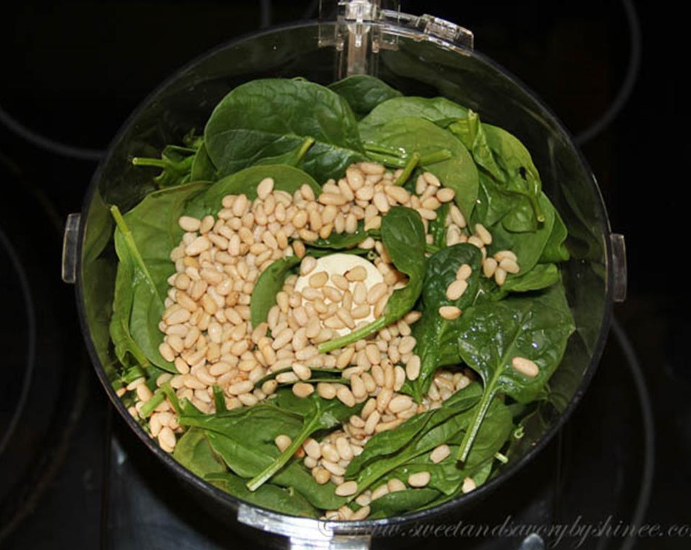 step 2 Place Fresh Baby Spinach (10 cups), toasted pine nuts, and juice from Lemons (2 1/2) in a food processor.