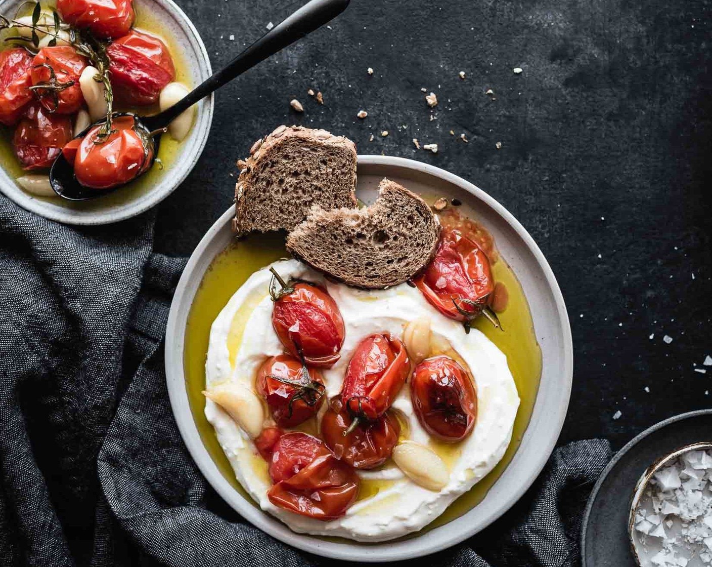step 7 Spread a bed of whipped feta yogurt on each plate, top with tomato & garlic confit and serve with Bread (to taste) and some fried eggs if that sounds good to you!