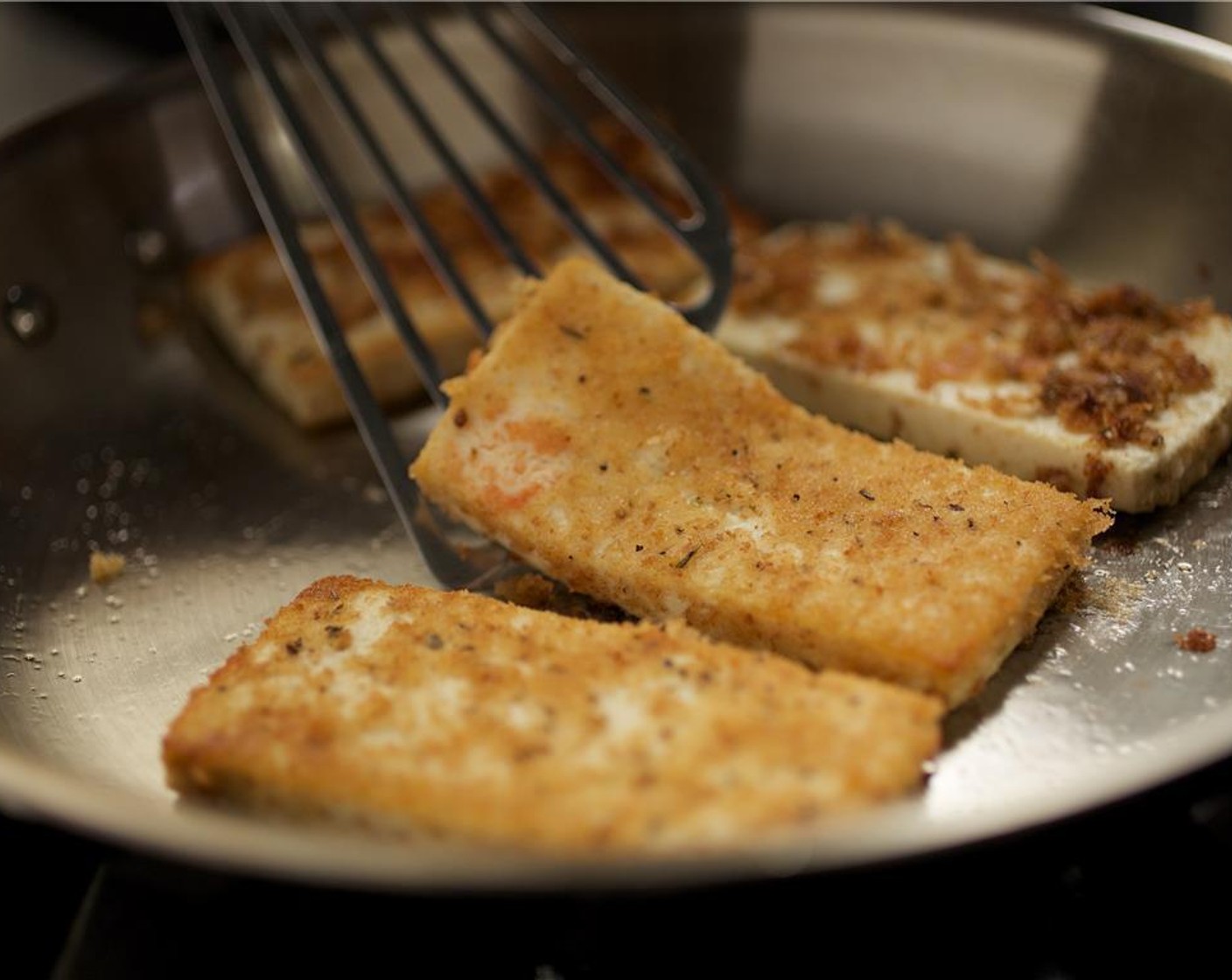 step 6 Heat a medium saute pan over medium heat. Add Olive Oil (1 Tbsp) and when hot, carefully add the tofu slices. Sear on each side for two minutes until golden brown.