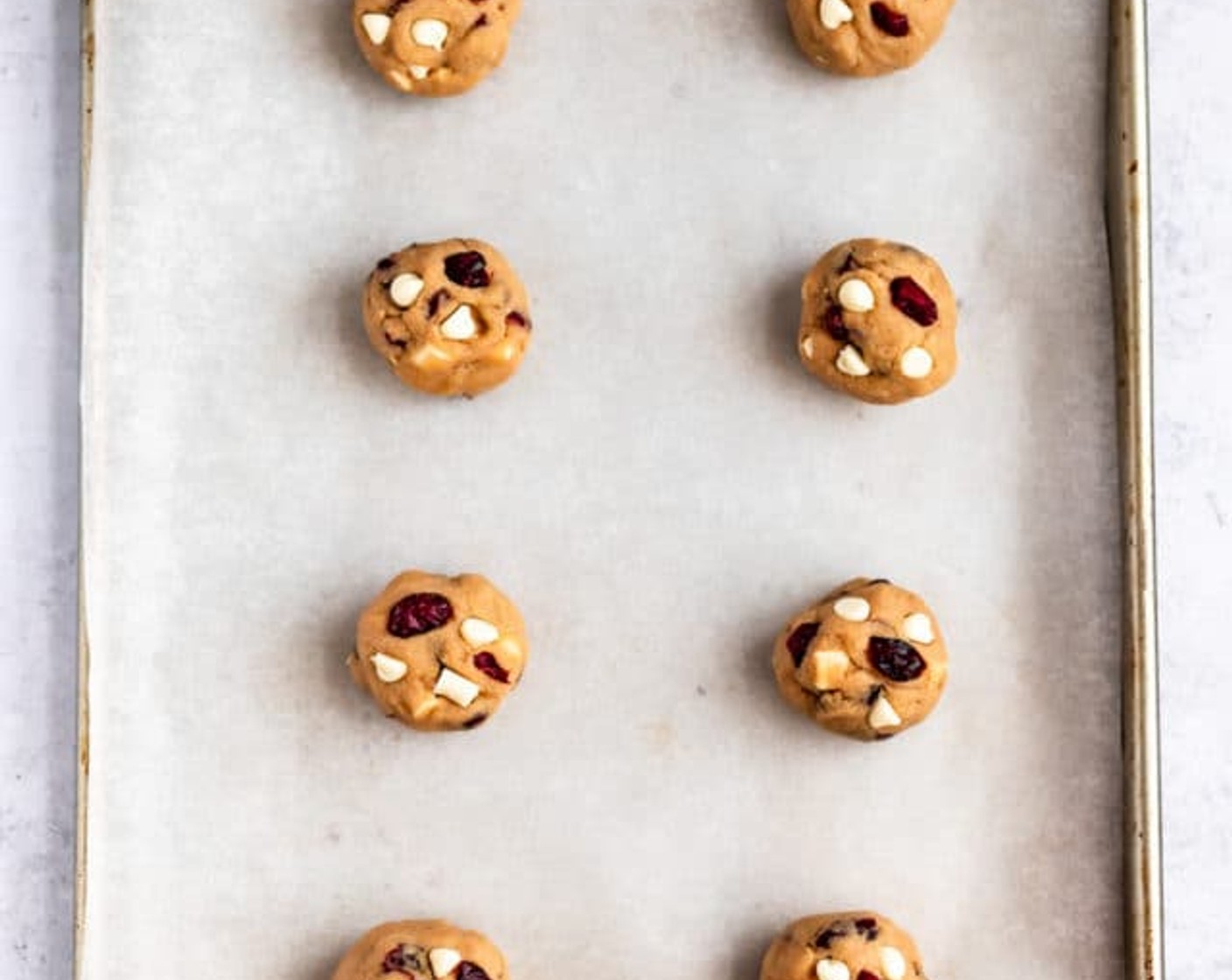 step 4 Drop rounded spoonfuls, about 2 Tbsp of dough, 1-1/2 inches apart onto baking sheets. Add a few white chocolate morsels and cranberries to the tops of the cookies for a prettier cookie.