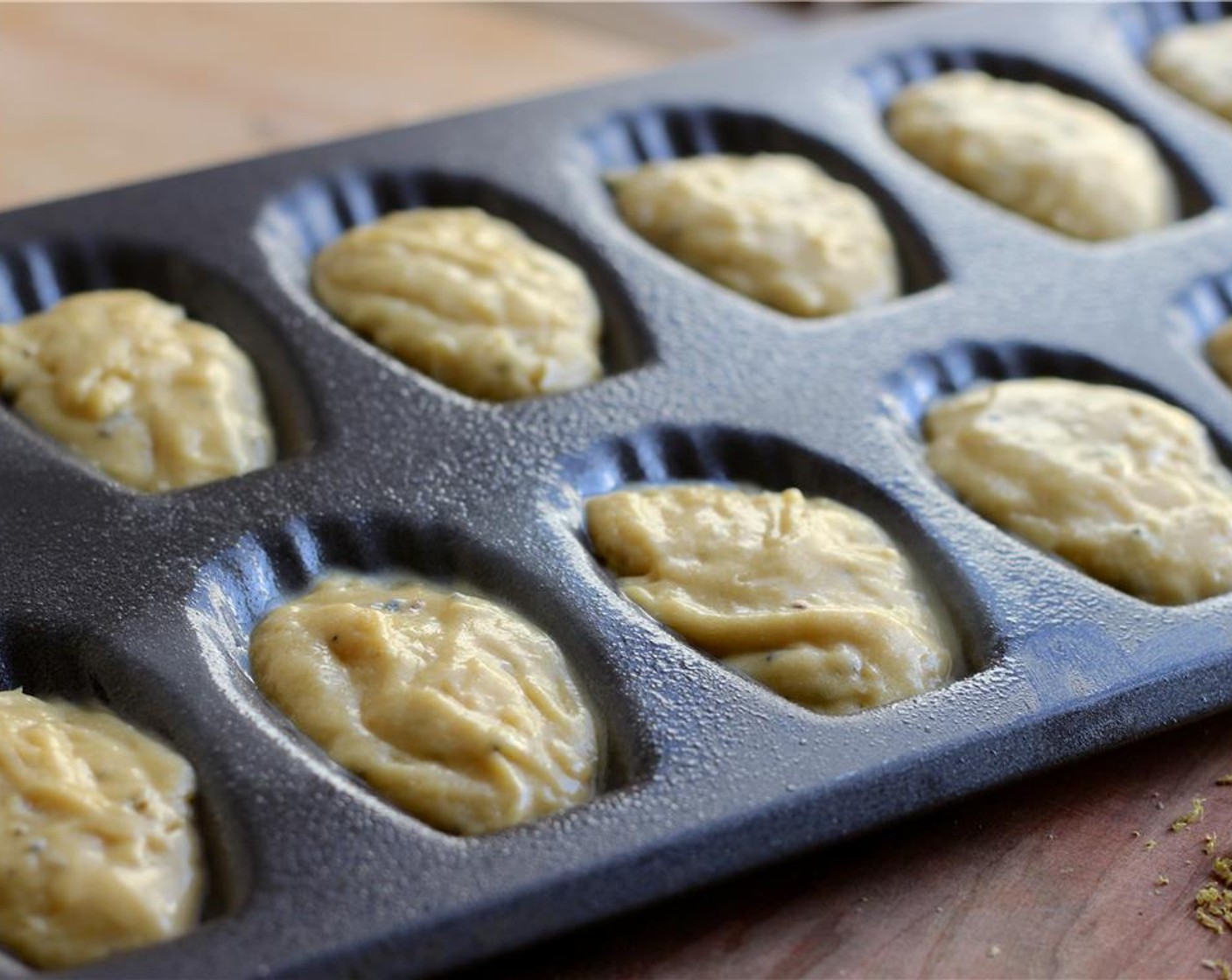 step 8 Spoon the batter into the molds 3/4 of the way full without spreading the batter around. Bake for 7-9 minutes in the upper third part of the oven. The madeleines are done when they are golden and slightly firm to the touch.