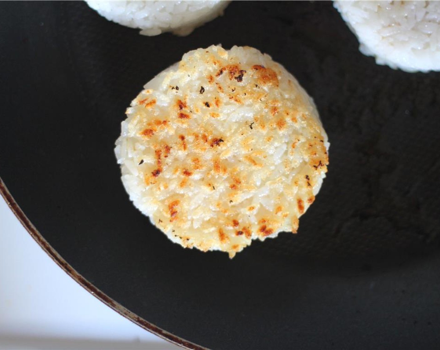 step 13 Once you've formed all the onigiri, sprinkle with Sesame Seeds (1 Tbsp) and grill in pan with just a little sesame oil. Each side should brown in about 3-4 minutes on high heat.