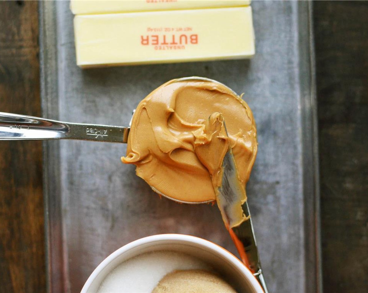 step 3 In another bowl, cream together Unsalted Butter (1 cup) and Creamy Natural Peanut Butter (1 1/2 cups). Add Granulated Sugar (3/4 cup) and Brown Sugar (3/4 cup) and continue to cream until well combined.