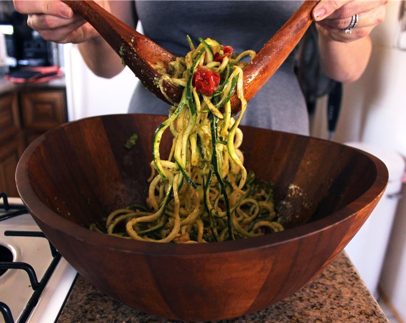 step 7 When the tomatoes are cooked, immediately toss them with the raw zucchini noodles and Basil Pesto (1/3 cup) in a salad bowl.