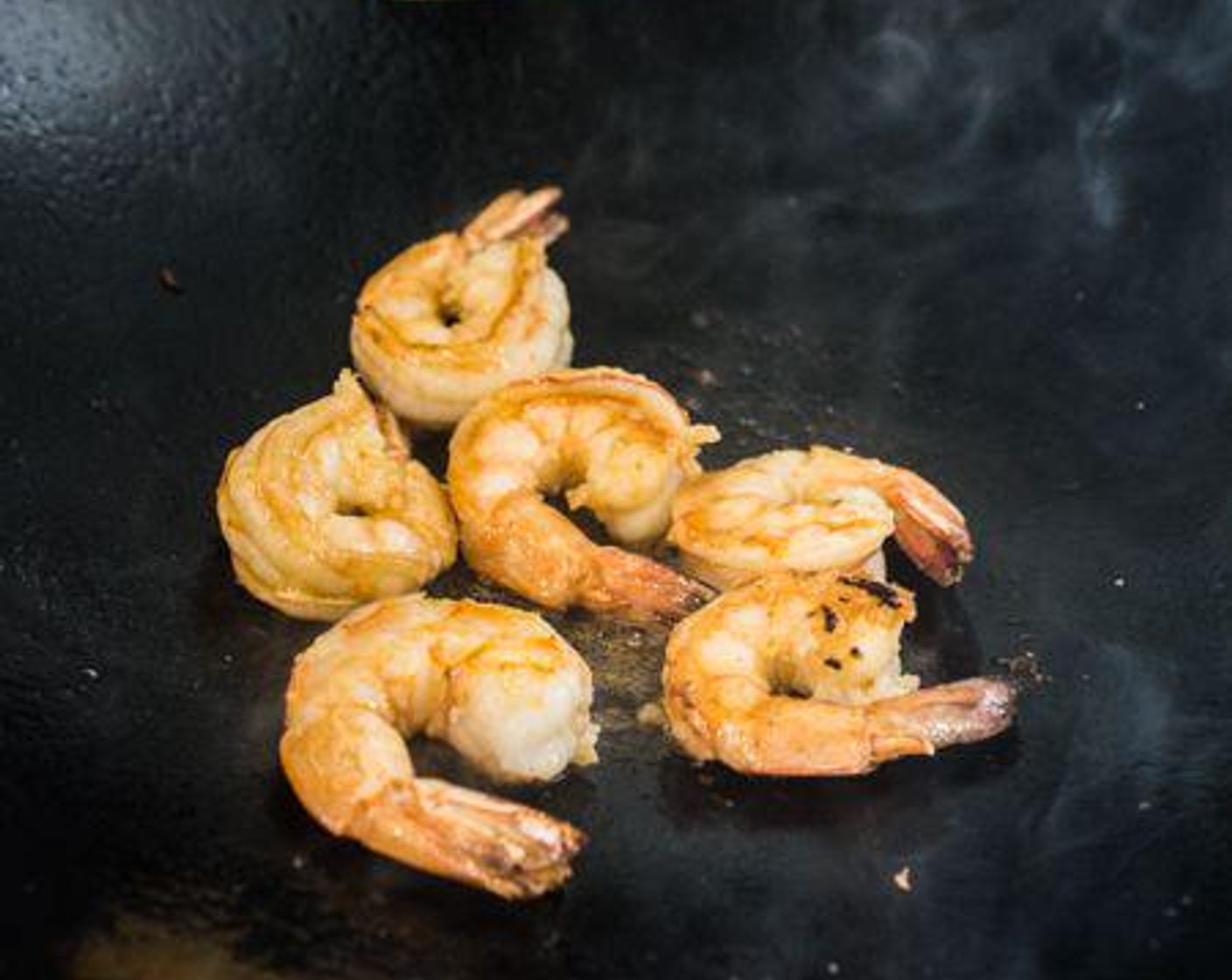 step 5 Heat Peanut Oil (1 Tbsp) in a wok over medium-high heat. Stir-fry the Large Shrimp (6) for 30 seconds, add 1/2 tablespoon of the Pad Thai sauce, then fry for the shrimp for 30 more seconds or until the shrimp are fully cooked. Remove from the wok and set aside.