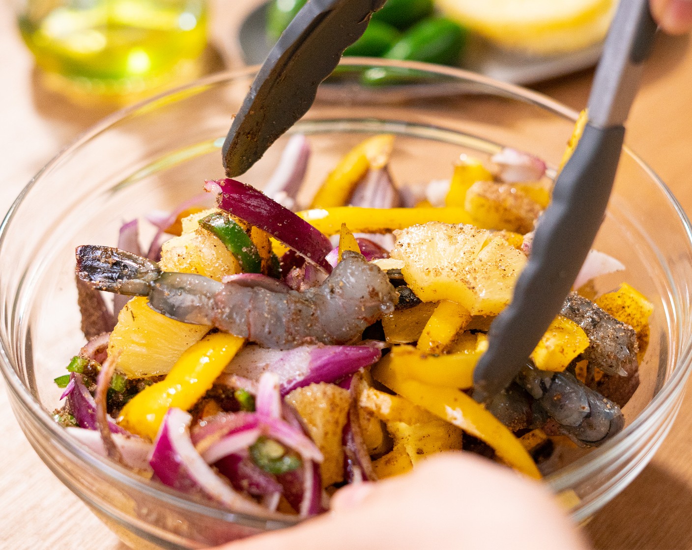 step 2 In a large mixing bowl, toss together the Large Shrimp (1 lb), Yellow Bell Pepper (1), Pineapple (1 can), Jalapeño Pepper (1), and Red Onion (1/2) with Olive Oil (1 Tbsp), Jerk Seasoning (2 Tbsp), Lime (1/4) and Brown Sugar (1 tsp).