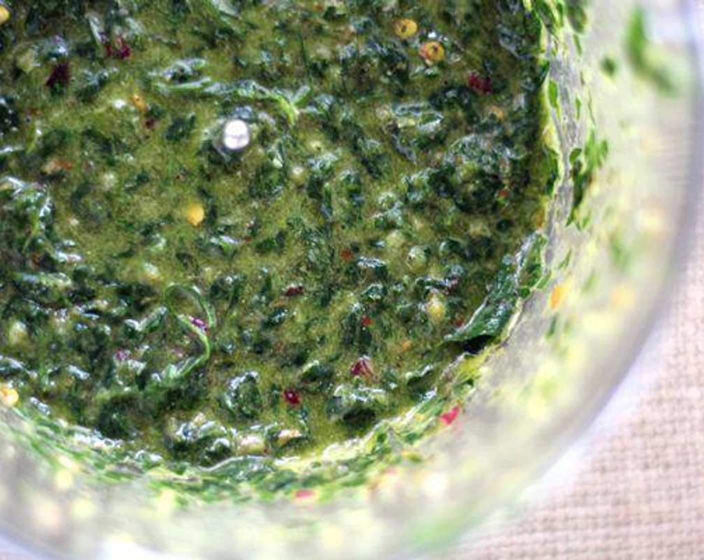 step 3 In a food processor, combine the Chimichurri (1 Tbsp), Italian Flat-Leaf Parsley (2 cups), Lime (1), Red Onions (2 Tbsp), Crushed Red Pepper Flakes (1/2 tsp), Garlic (1 Tbsp), Salt (1/2 tsp), and Ground Black Pepper (1/2 tsp). Pulse until well combined. Gradually add Olive Oil (1/2 cup), blending and processing until well blended. Set aside.