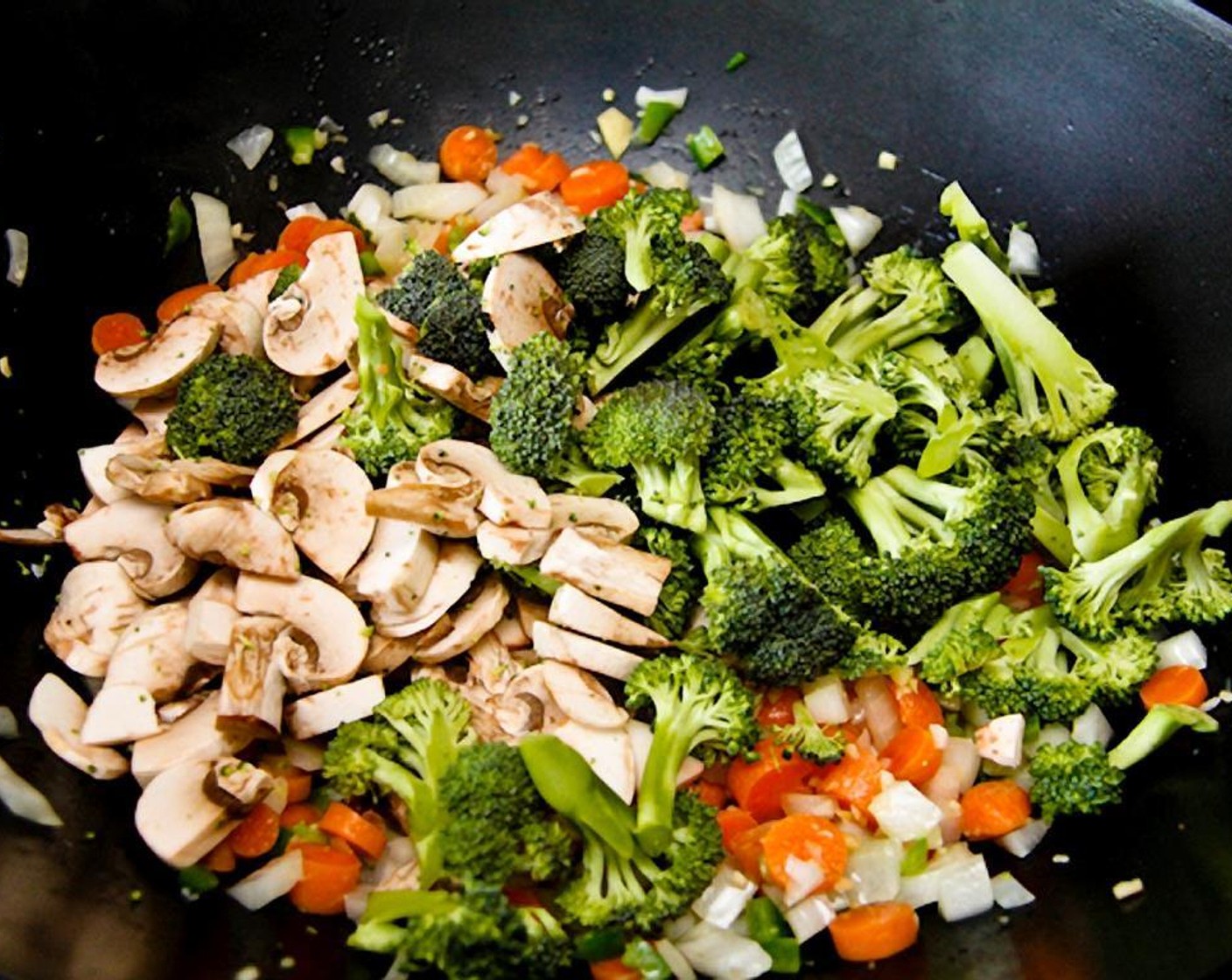 step 8 Add the broccoli and mushrooms and 2 tablespoons of the sauce and stir.