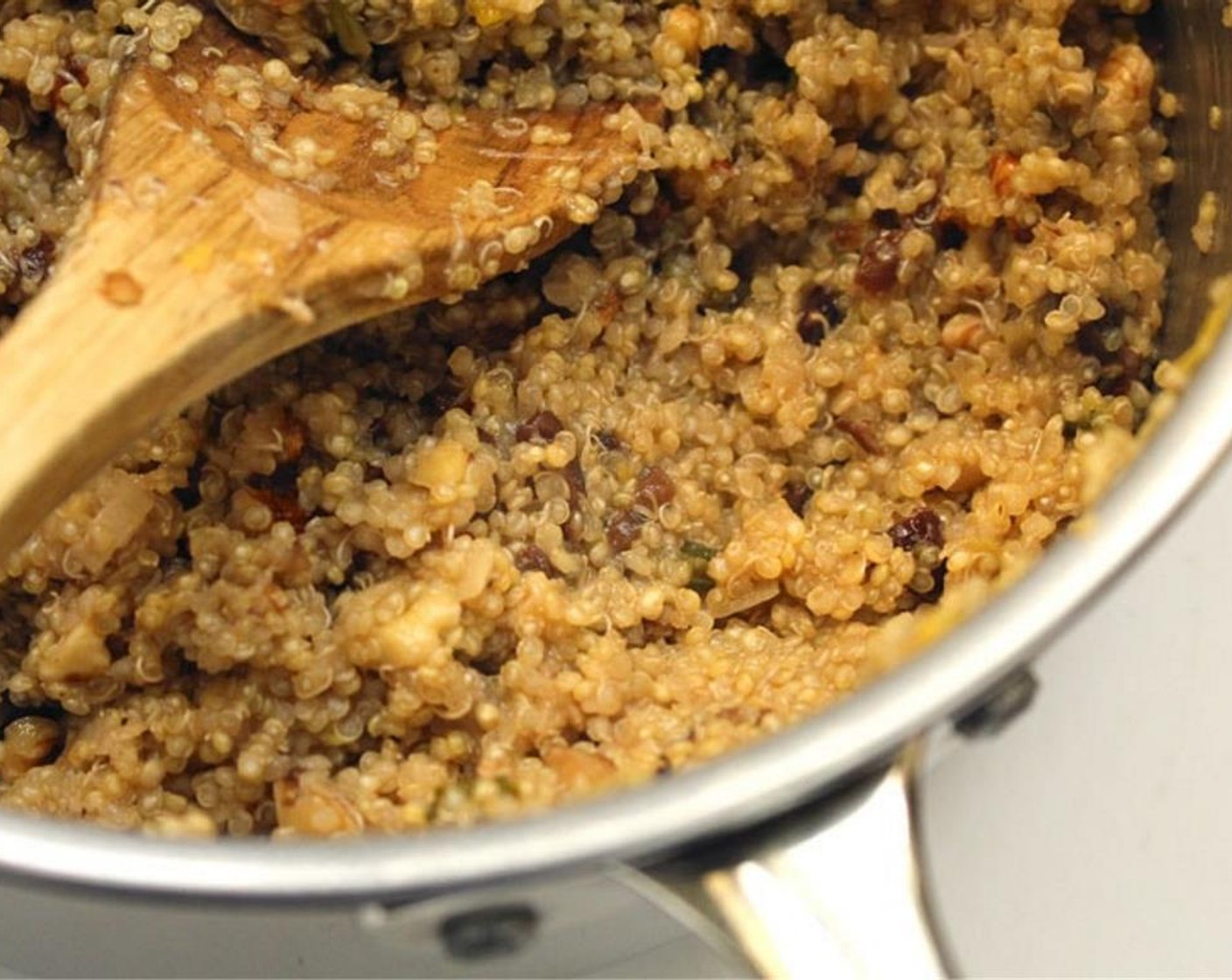 step 3 Add Quinoa (1 cup), Lemon (1), Raisins (1/4 cup), Cayenne Pepper (1 dash), Salt (to taste), and Ground Black Pepper (to taste). Cook for about 2 minutes.