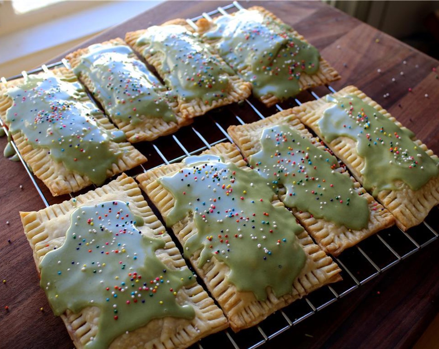 step 10 When the pop tarts are cool, spoon the glaze over the tops and immediately cover them in Sprinkles (to taste). Let the glaze set for a few minutes, and then serve immediately or store at room temperature in an airtight container.