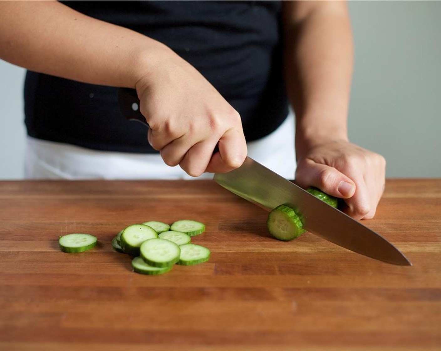 step 3 Next, slice the Persian Cucumber (1) into quarter inch rounds and place in a second medium bowl. Slice the Shallot (1) in half lengthwise then into quarter inch half moons. Add to the same bowl.