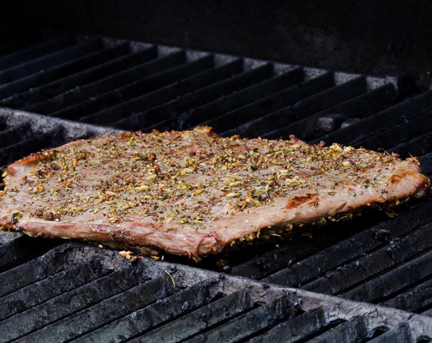 step 7 Preheat the grill to high heat (about 500 degrees F or 260 degrees C). Place the steak on the grill and turn the heat down to a medium-high heat (about 450 degrees F or 230 degrees C). Grill 5 to 6 minutes per side for a medium-rare steak.