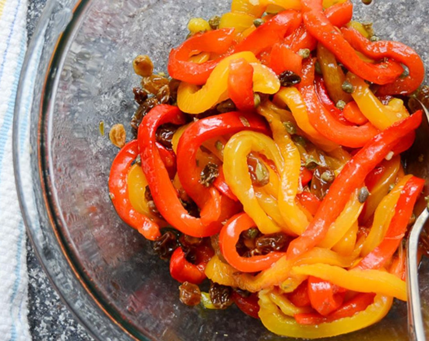 step 9 Peel and seed the peppers. Slice the peppers very thinly and return to the bowl with the raisins.