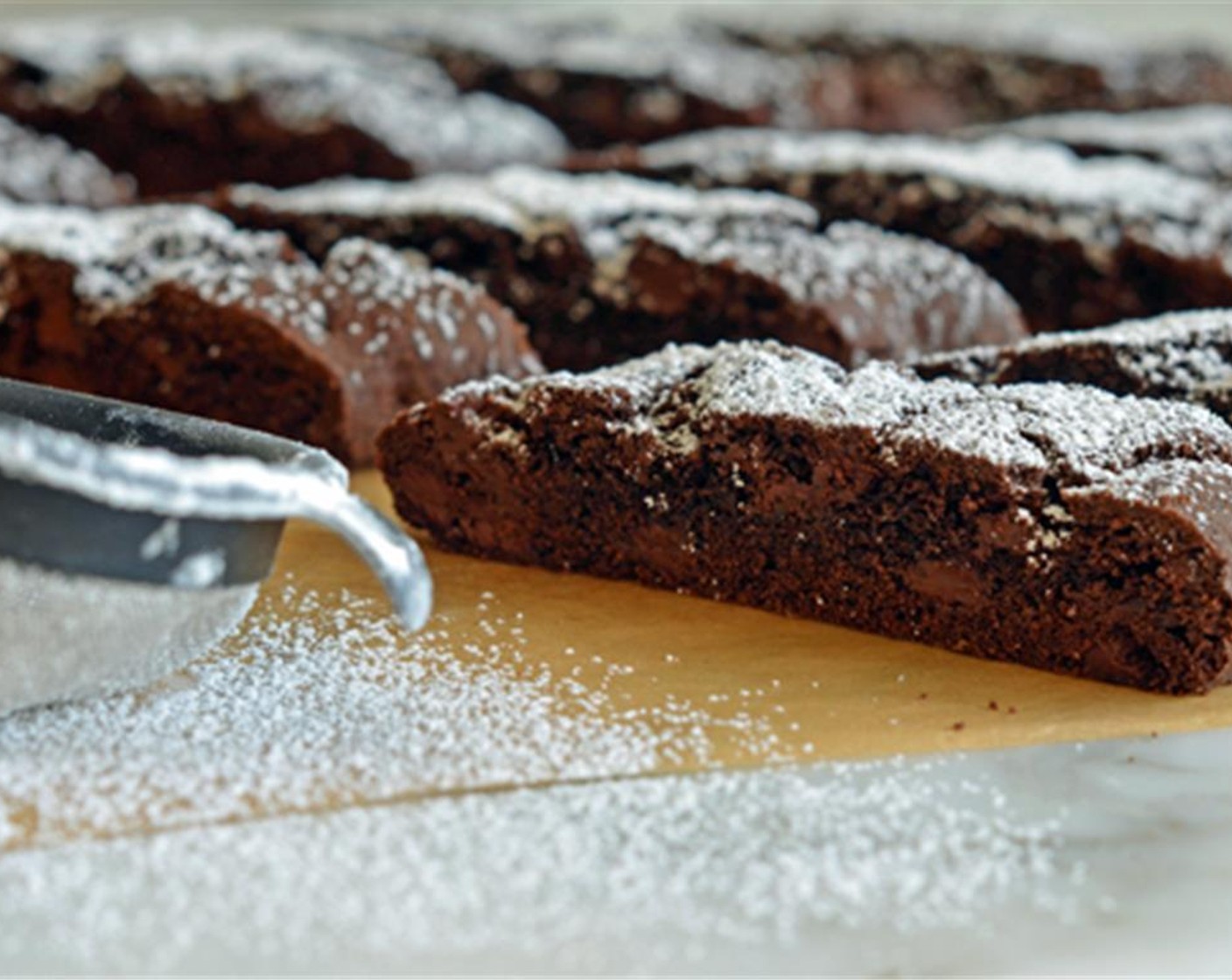 step 13 When cool, push all the biscotti together. This prevents the Powdered Confectioners Sugar (1 Tbsp) from getting on the sides of the cookies. Use a fine sieve to dust with Confectioners sugar. Serve with coffee, tea or warm milk, and enjoy!