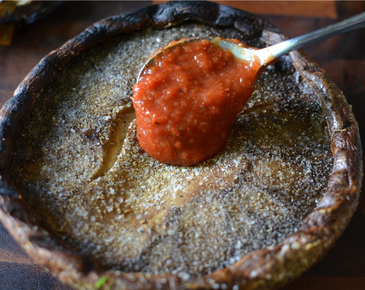 step 6 Then take the mushrooms off the grill and prepare the pizza part of this recipe. Smother some Pizza Sauce (to taste) into the mushroom cavity.