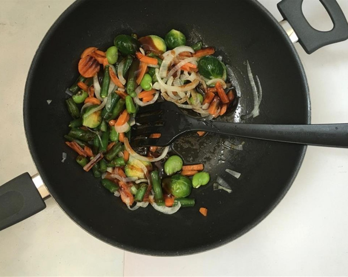 step 3 Then sprinkle the vegetables with the Oyster Sauce (2 Tbsp), Soy Sauce (1 Tbsp), Sesame Oil (1 tsp) and Fish Sauce (1 tsp). Add 3 tablespoons of water as well. Season with a pinch of Ground Black Pepper (to taste).