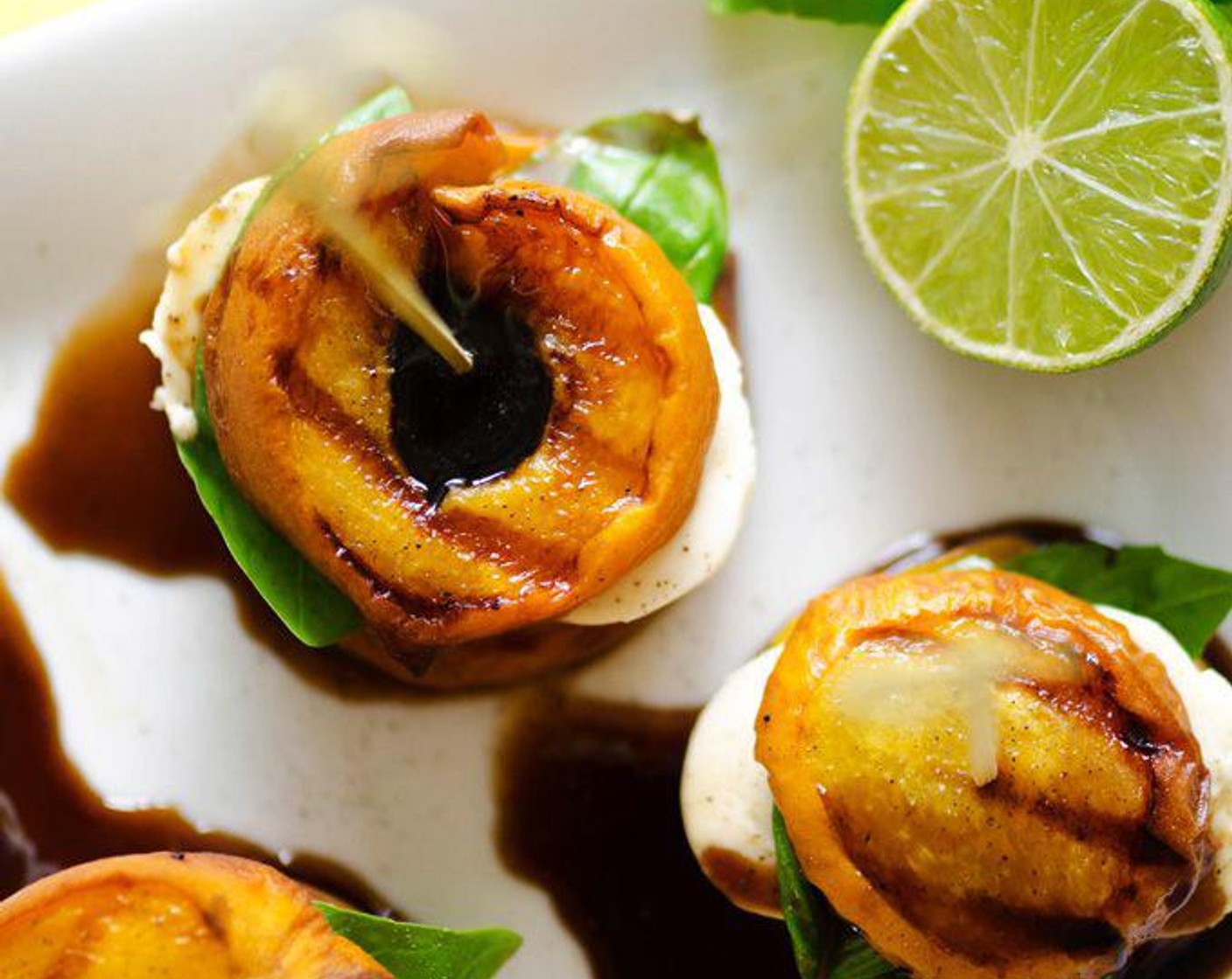 step 6 Arrange caprese stacks by layering a slice of peach, a few leaves of basil, a slab of mozzarella, and another peach. Secure with a toothpick if desired.