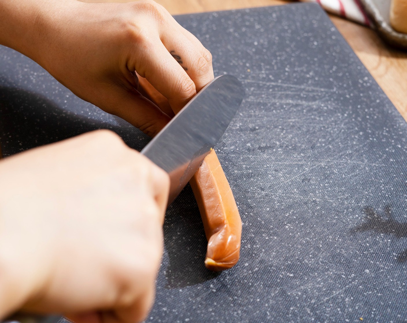 step 2 Cut several slits on two sides of Hot Dogs (4) or cut into shallow Vs or Xs.